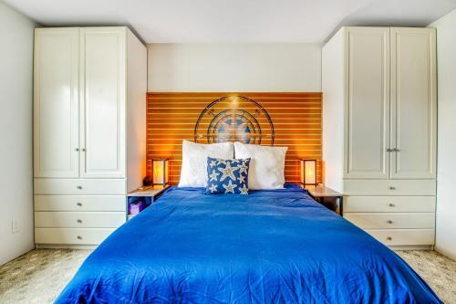 a bedroom with a blue bed with white cabinets at Bay Watch North in Birch Bay
