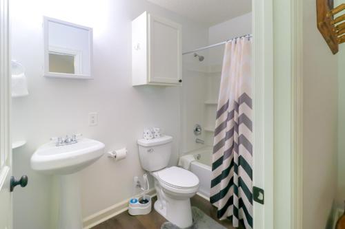 a white bathroom with a toilet and a sink at Little Bear Retreat 2 in Helen