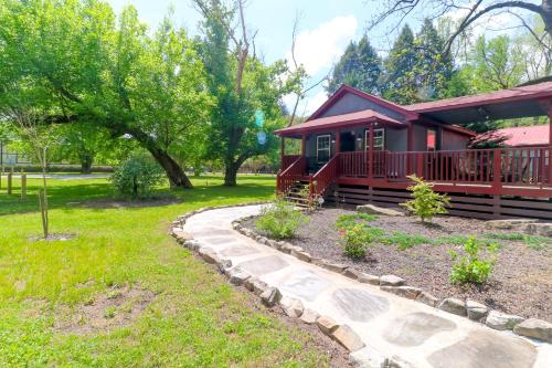 a red cabin with a walkway in front of a yard at Little Bear Retreat 2 in Helen