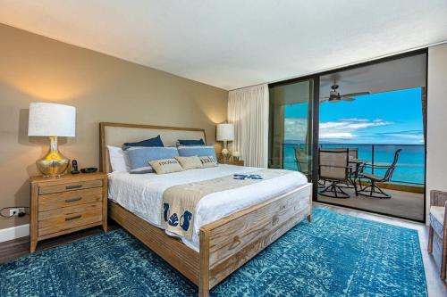 a bedroom with a bed with a view of the ocean at Mahana 316 in Kaanapali