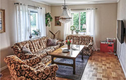 a living room with a couch and a table at Gorgeous Home In Sunnemo in Sunnemo