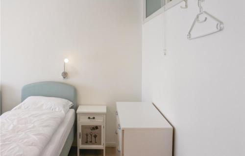 a small bedroom with a bed and a table at 2 Bedroom Awesome Apartment In Paesens in Paesens