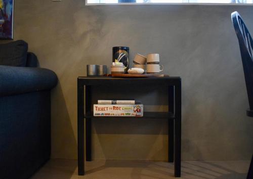 a small table with a book on top of it at The Hans Apartment - cosy and special in Klaksvík