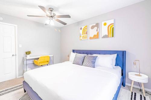 a white bedroom with a blue bed and a ceiling fan at Central 1BR King Bed Suites, Close to Downtown & Domain in Austin