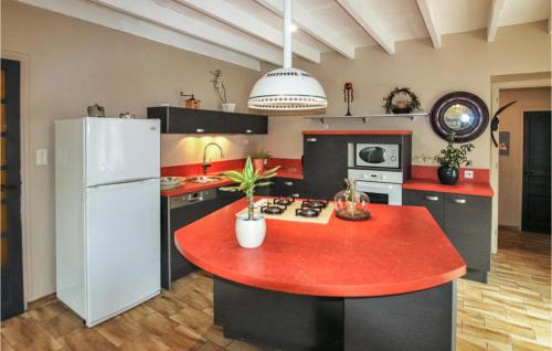 a kitchen with a red island in the middle at Cozy Home In Montoison in Montoison
