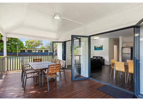 a dining area with a table and chairs on a deck at Discovery Parks - Rockhampton in Rockhampton