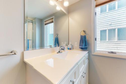 a bathroom with a white sink and a mirror at Fenwick Island - 38829 Bunting Avenue #1 in Fenwick Island