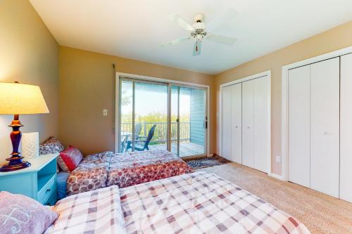 a bedroom with a bed and a ceiling fan at Fenwick Island - 38829 Bunting Avenue #1 in Fenwick Island