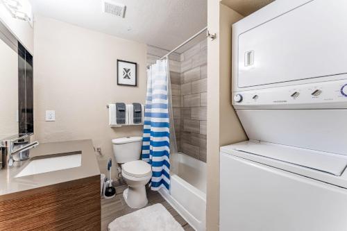 a bathroom with a toilet and a sink with aaucet at Extended Stay Apartments Next to Downtown in Austin