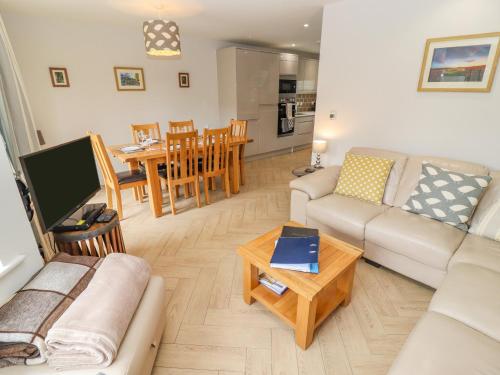 a living room with a couch and a table at Church View in Bourton on the Water
