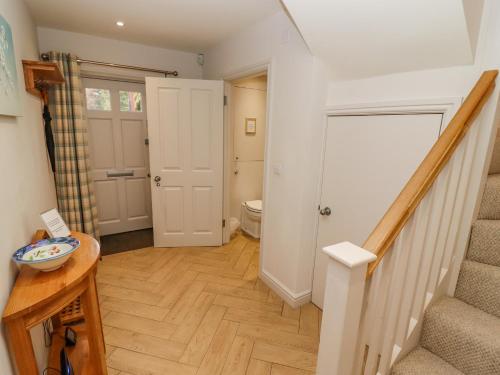 a hallway with a staircase and a toilet in a house at Church View in Bourton on the Water