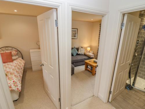 a bedroom with a bed and a couch in a room at Church View in Bourton on the Water