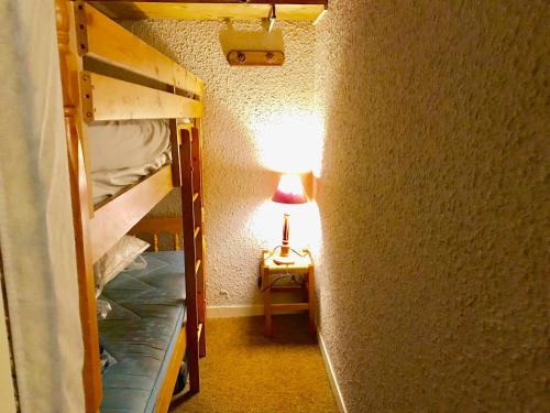 a room with two bunk beds and a lamp at Studio Corrençon-en-Vercors, 1 pièce, 4 personnes - FR-1-515-125 in Corrençon-en-Vercors