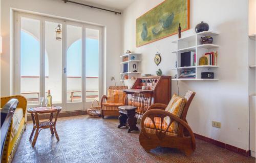 a living room with chairs and a table at Amazing Home In San Piero In Campo in San Piero in Campo