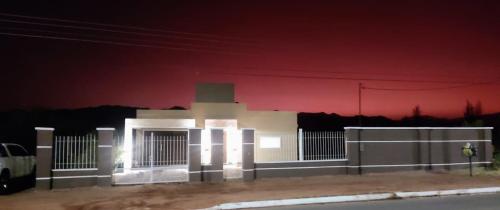 a white building with lights on it at night at Casa Quinta in Villa Unión