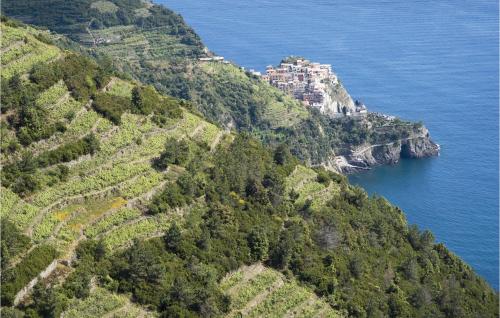 a village on the side of a mountain next to the ocean at Cozy Home In Castagnetoli in Mulazzo