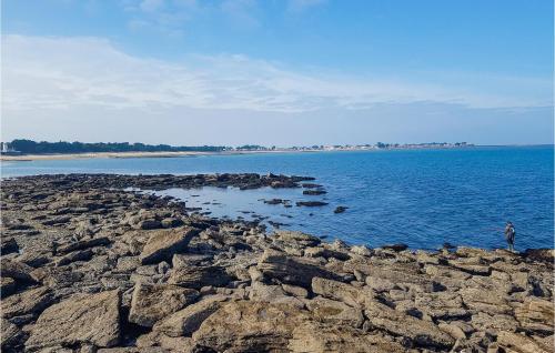 a person standing on the rocks in the water at Nice Apartment In Noirmoutier-En-L'île in Noirmoutier-en-l'lle