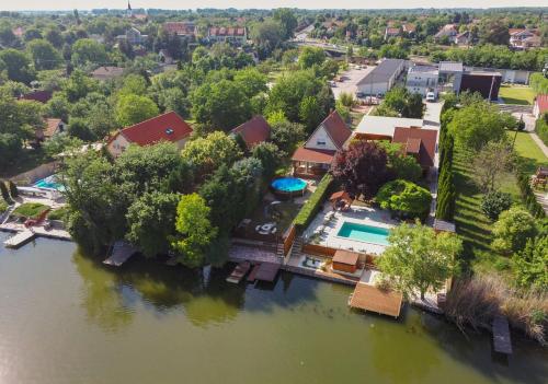 an aerial view of a house next to a river at Sinka Vendégház in Békésszentandrás