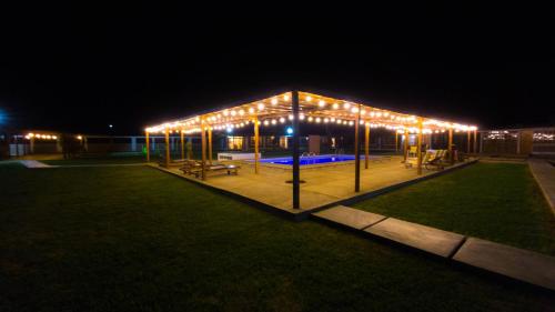 a pavilion with lights in a park at night at Casa Solaris in Ica