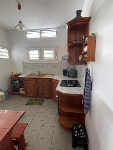 a kitchen with a sink and a stove top oven at CD House in Fort-de-France