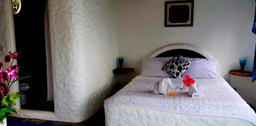 a bedroom with a bed with two stuffed animals on it at Kim's Garden in Anda