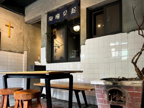 a table and chairs in a kitchen with a fireplace at 以安二館 in Lugang