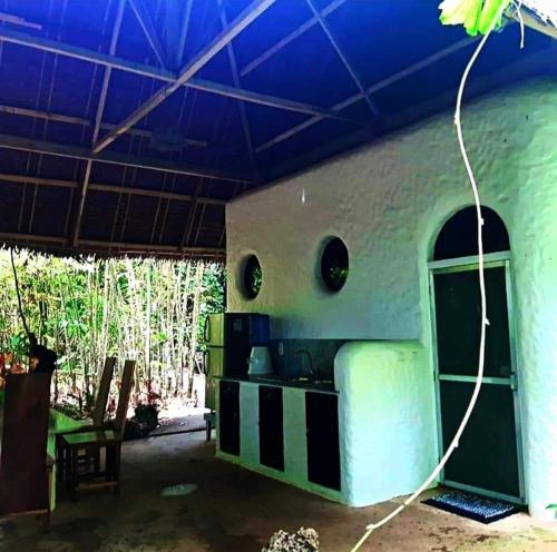 a kitchen in a house with a blue ceiling at Kim's Garden in Anda