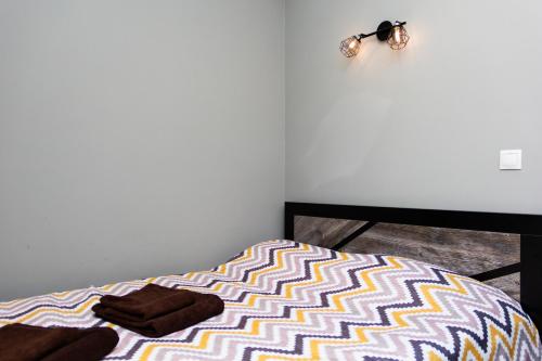 a bedroom with a bed with towels on it at Hotel Tahar in Almaty