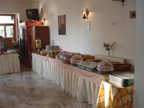 a long table with food on it in a room at Oscar Hotel Lefkada in Nydri