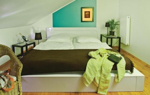 a bedroom with a large bed with a brown blanket at Nice Home In Pinnow With Wifi in Petersberg