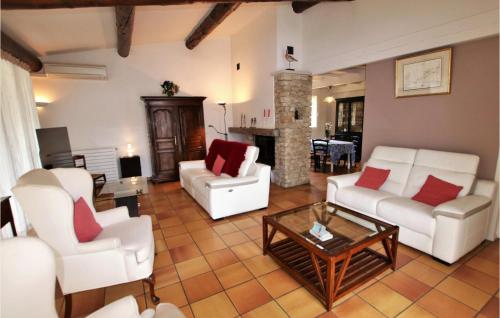 a living room with white furniture and a fireplace at Cozy Home In Condorcet in Condorcet