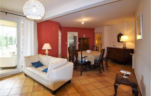 a living room with a white couch and a table at Cozy Home In Condorcet in Condorcet