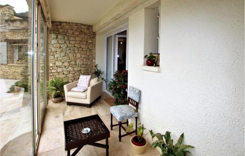 a living room with a couch and a chair at Cozy Home In Condorcet in Condorcet