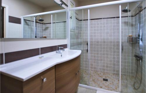 a bathroom with a sink and a shower at Cozy Home In Condorcet in Condorcet