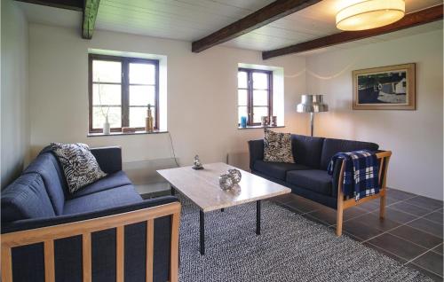 a living room with two couches and a coffee table at 3 Bedroom Beautiful Home In Klagstorp in Klagstorp