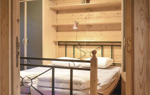 a bedroom with a bunk bed with a wooden headboard at Ranchero in Wachtebeke