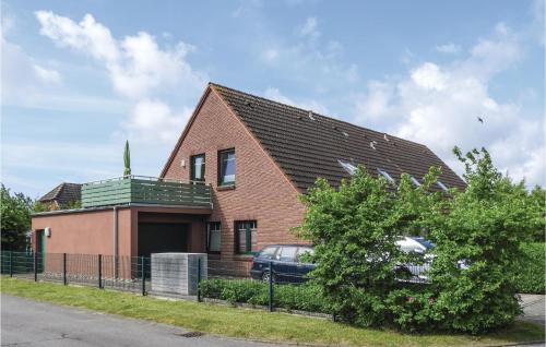 a house with a car parked in front of it at 2 Bedroom Cozy Apartment In Dagebüll in Dagebüll