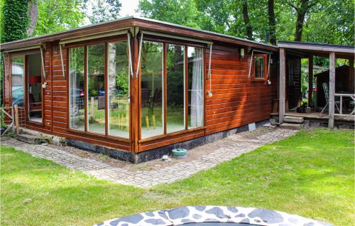a wooden cabin with glass windows in a yard at 2 Bedroom Lovely Home In Overberg in Overberg