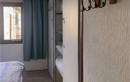 a room with a closet with a bed and a window at 2 Bedroom Lovely Home In Overberg in Overberg