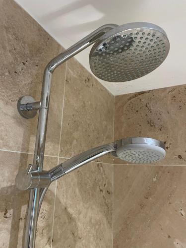 a shower with a shower head in a bathroom at Brackfield House Deal 49 in Killaloo