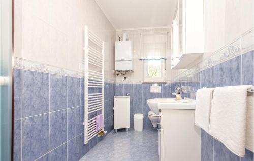 a blue and white bathroom with a sink and a toilet at Beautiful Apartment In Smrika With Wifi in Šmrika