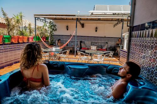 un hombre y una mujer en un jacuzzi en Hostel Triana Backpackers, en Sevilla