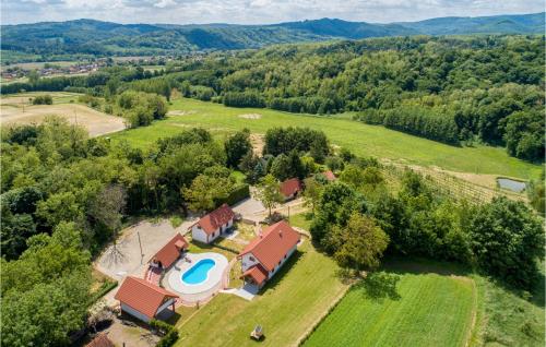 an aerial view of a house with a swimming pool in a field at Lovely Home In Rivalno With Sauna in Slanje