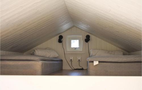 two beds in a room with a attic at Lovely Home In Hasslö With Kitchen in Hasslö