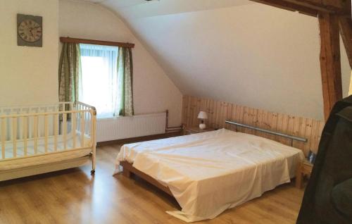 a bedroom with a bed and a crib at Holiday Home Schönberg With Table Tennis 194 in Schoenberg
