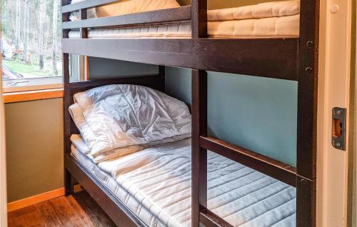 a set of bunk beds in a room at Amazing Home In Hommersk With House Sea View in Hommersåk