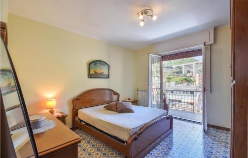 1 dormitorio con 1 cama y puerta a un balcón en 1 Bedroom Stunning Apartment In Recco, en Recco