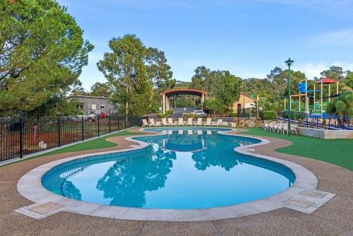 a pool at a park with a playground at Discovery Parks - Dubbo in Dubbo