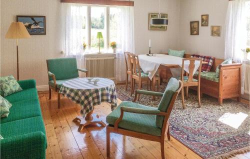a living room with a table and chairs at Holiday Home Lilla Öboängen Lidköping in Sjövik