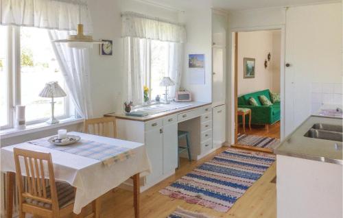 a kitchen with a table and a dining room at Holiday Home Lilla Öboängen Lidköping in Sjövik